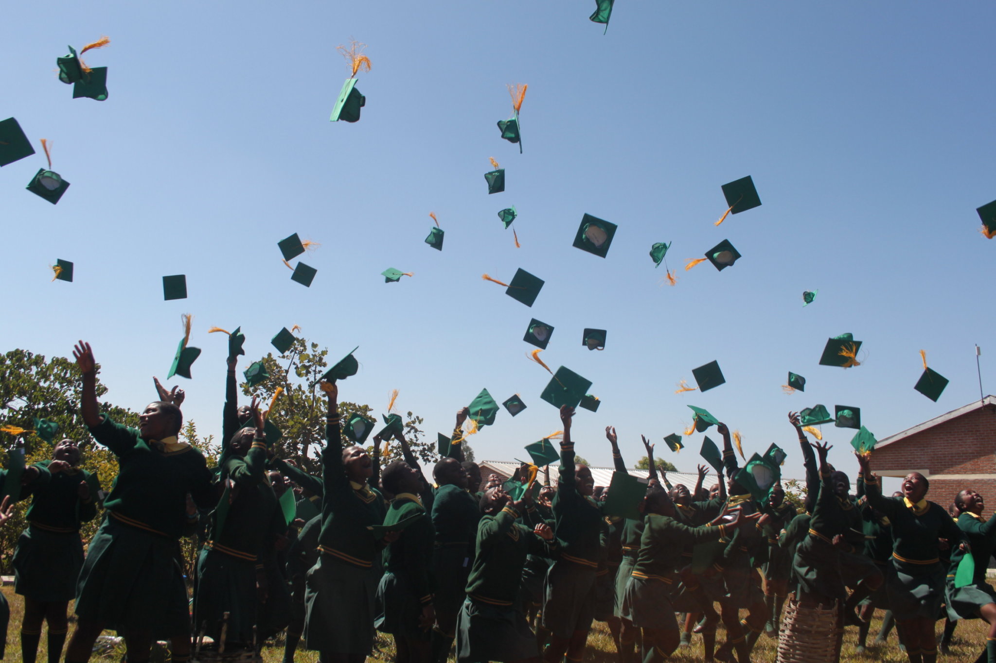 Graduatesthrowingcaps